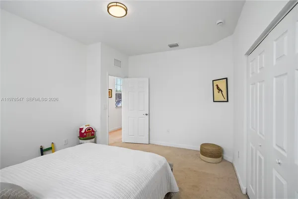 a bedroom with a bed and a potted plant