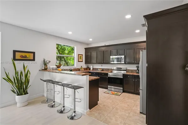 a kitchen with a sink a counter top space and appliances