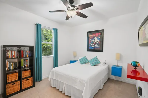 a bedroom with a bed and window
