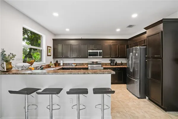 a kitchen with counter top space cabinets and stainless steel appliances