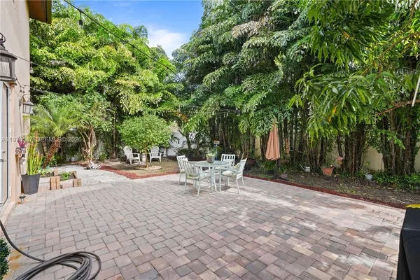 a view of backyard of house with seating space