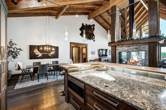 a view of living room kitchen with furniture and fireplace
