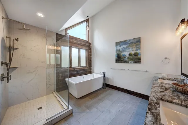 a bathroom with a tub sink and mirror