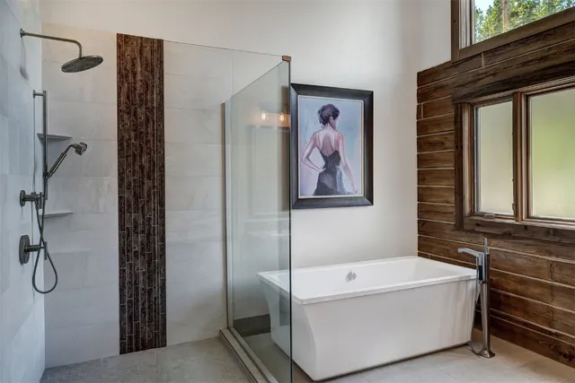 a bathroom with a bathtub and a shower