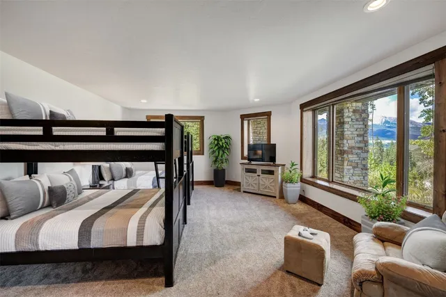 a bedroom with furniture and a large window