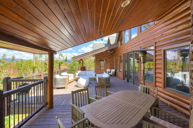 a view of a patio with table and chairs and wooden floor