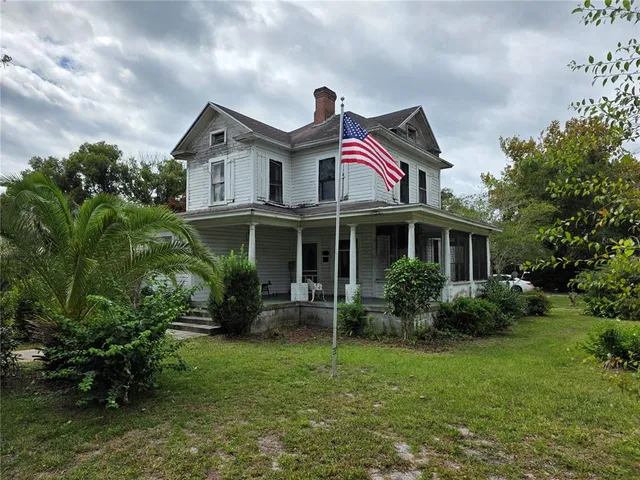 a front view of house with yard and green space