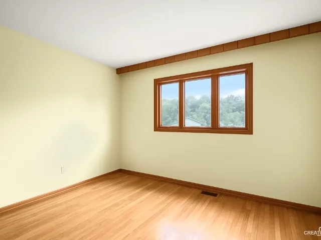 an empty room with closet and furniture