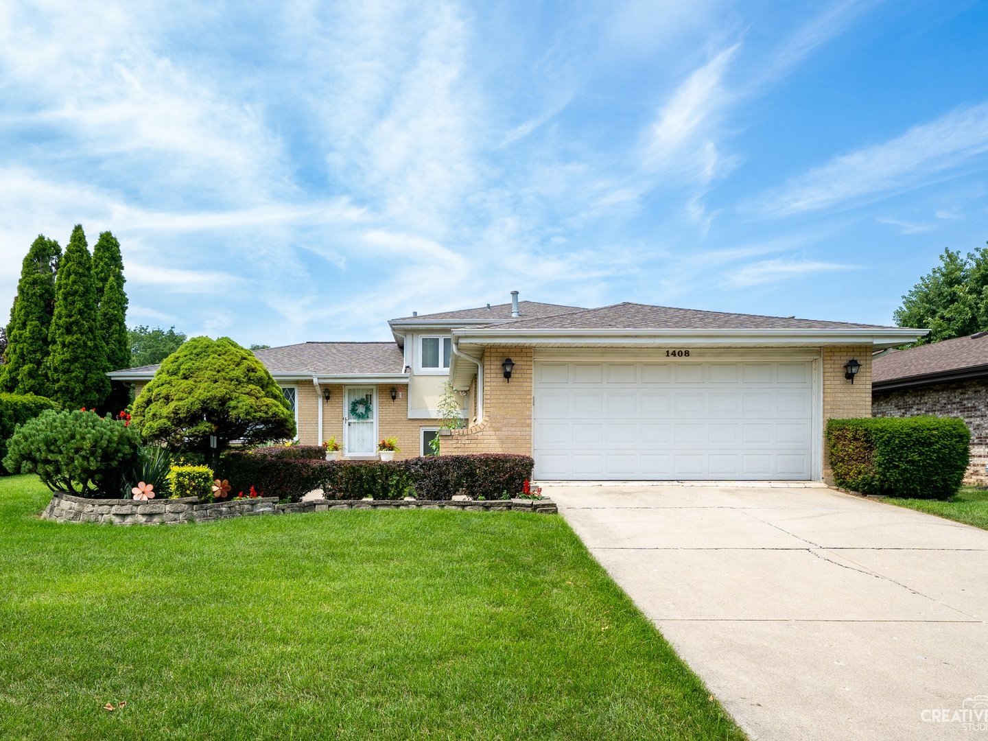 1408 Spruce Lane Westmont, IL 60559 - Photo 2 of 25 a front view of a house with a garden and plants