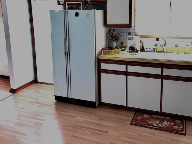 a kitchen with sink refrigerator and window