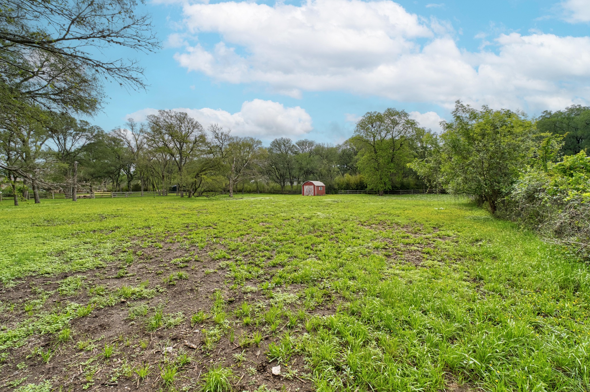 7 Pillow Road Sunset Valley, TX 78745 - Photo 12 of 22 a view of a green field with wooden fence