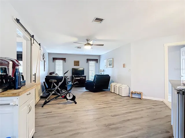a view of a livingroom with workspace and a window