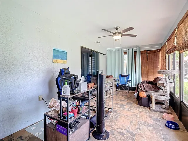 a view of a livingroom with workspace and a window