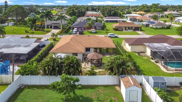an aerial view of a house with garden space and street view