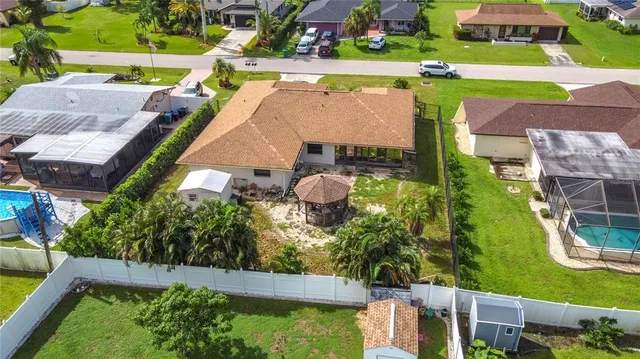 an aerial view of a house with a garden and plants