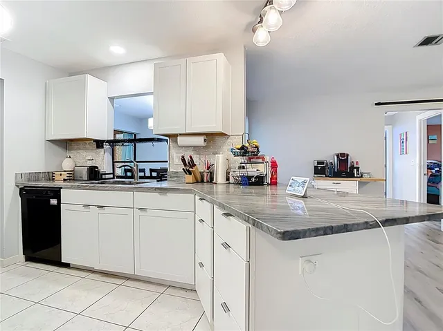 a kitchen with cabinets appliances and a sink