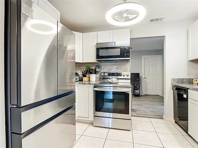 a kitchen with stainless steel appliances a stove a sink and a microwave