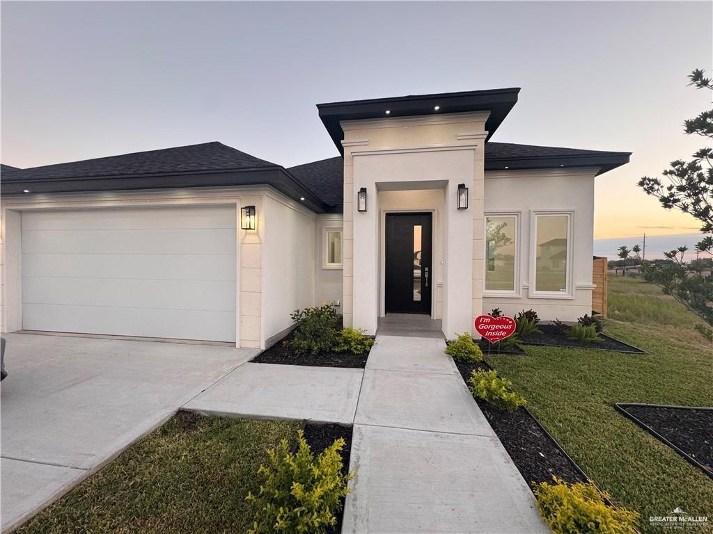 2724 East Conroe Road Edinburg, TX 78542 - Photo 1 of 1 View of front facade featuring a yard and a garage