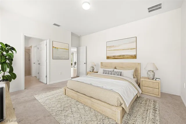 a bedroom with a bed and a potted plant