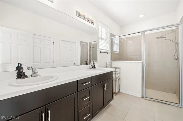 a bathroom with a sink double vanity and a mirror
