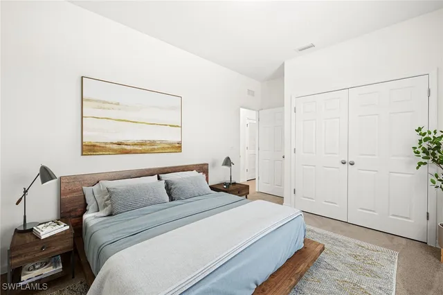 a bedroom with bed and window