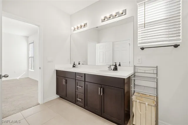 a bathroom with a double vanity sink a mirror and a