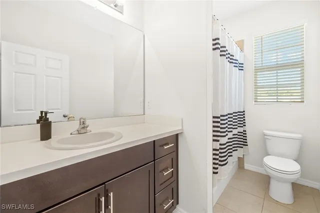 a bathroom with a toilet a sink and a mirror