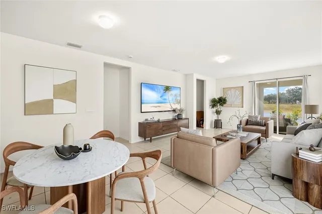 a living room with furniture a flat screen tv and a large window