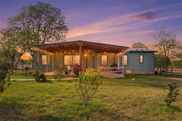 a view of a house with swimming pool and sitting area