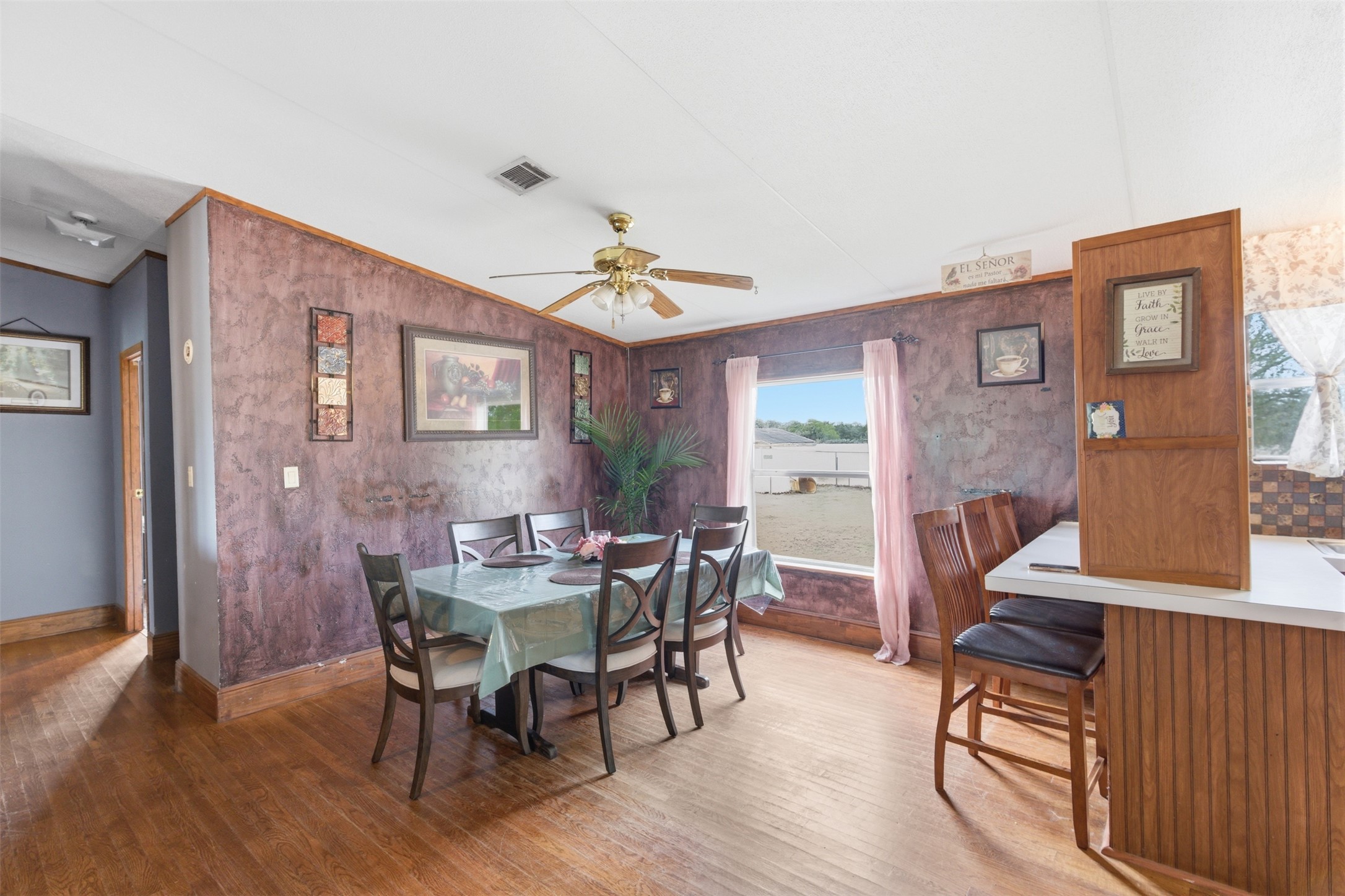 1150 Walter Hoffman Road Cedar Creek, TX 78612 - Photo 14 of 25 Dining room with light wood-style floors, lofted ceiling, ceiling fan, and ornamental molding