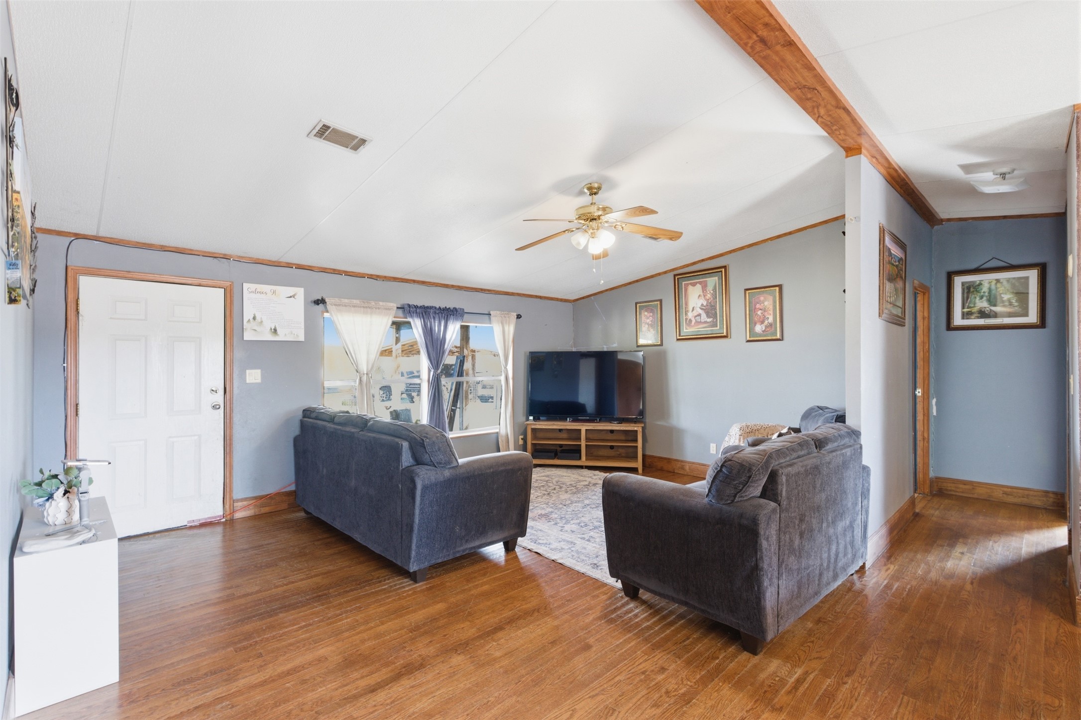 1150 Walter Hoffman Road Cedar Creek, TX 78612 - Photo 16 of 25 Living room featuring ornamental molding, hardwood / wood-style flooring, a ceiling fan, and lofted ceiling