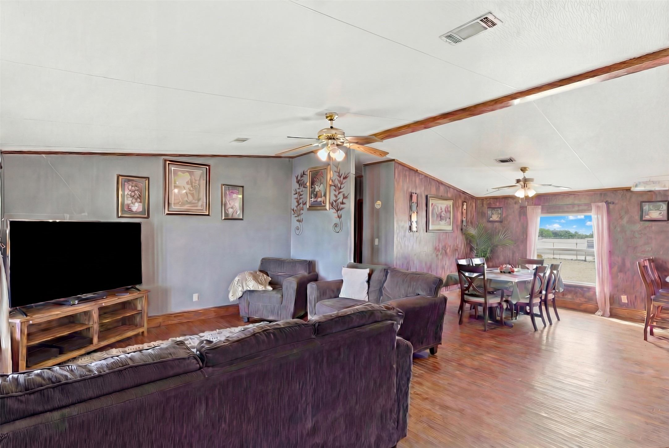 1150 Walter Hoffman Road Cedar Creek, TX 78612 - Photo 17 of 25 Living area with vaulted ceiling with beams, wood finished floors, and a ceiling fan