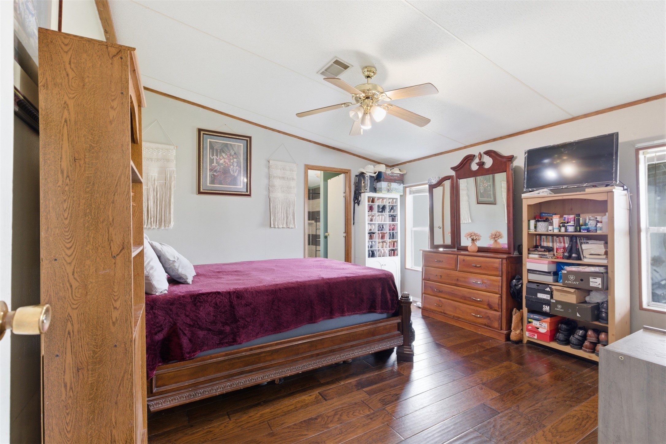 1150 Walter Hoffman Road Cedar Creek, TX 78612 - Photo 18 of 25 Bedroom with crown molding, dark wood finished floors, and ceiling fan