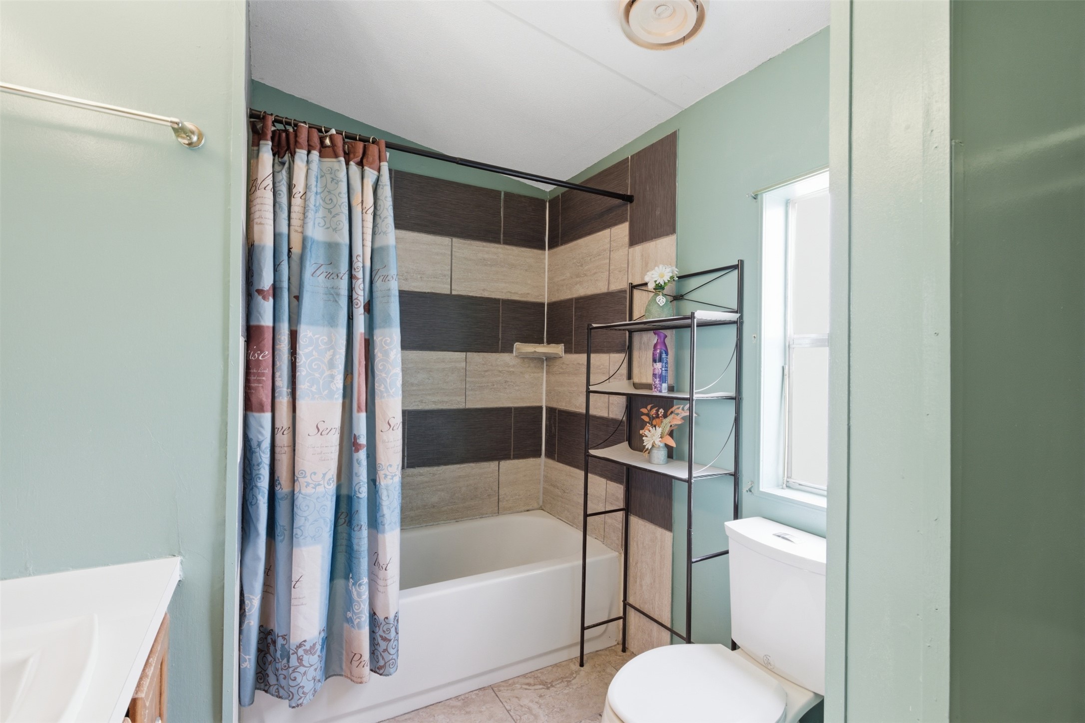1150 Walter Hoffman Road Cedar Creek, TX 78612 - Photo 19 of 25 Full bathroom featuring vanity, shower / bath combo, and light tile patterned flooring