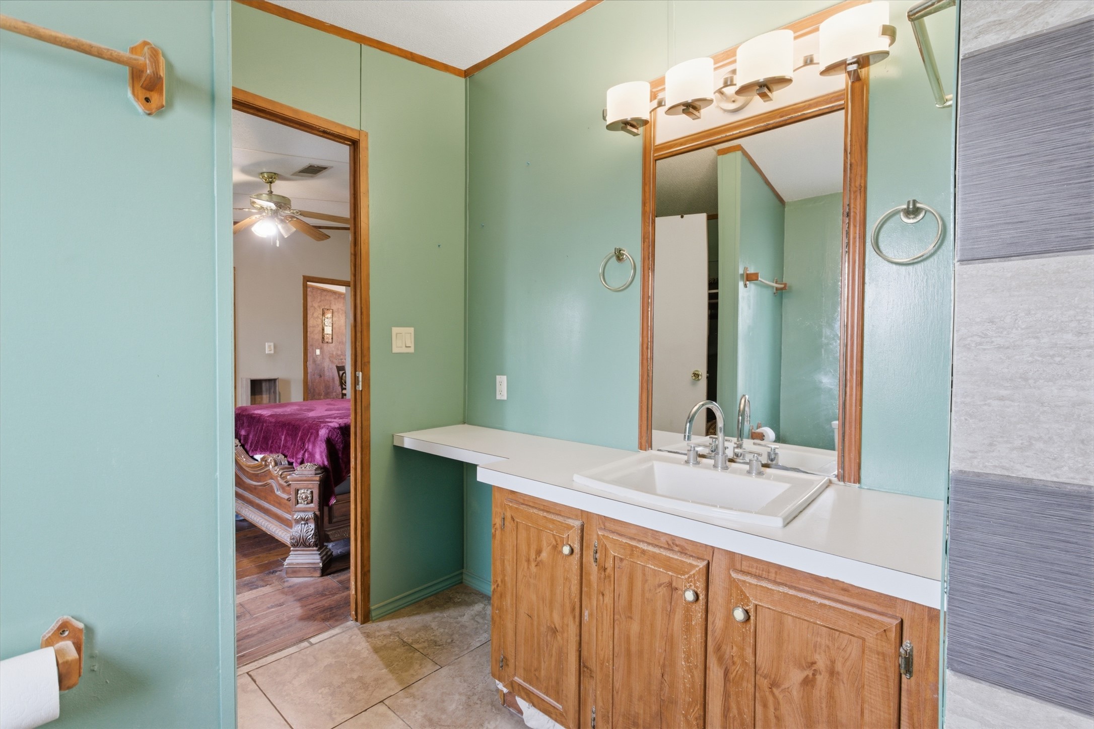 1150 Walter Hoffman Road Cedar Creek, TX 78612 - Photo 20 of 25 Bathroom featuring vanity, connected bathroom, and light tile patterned floors