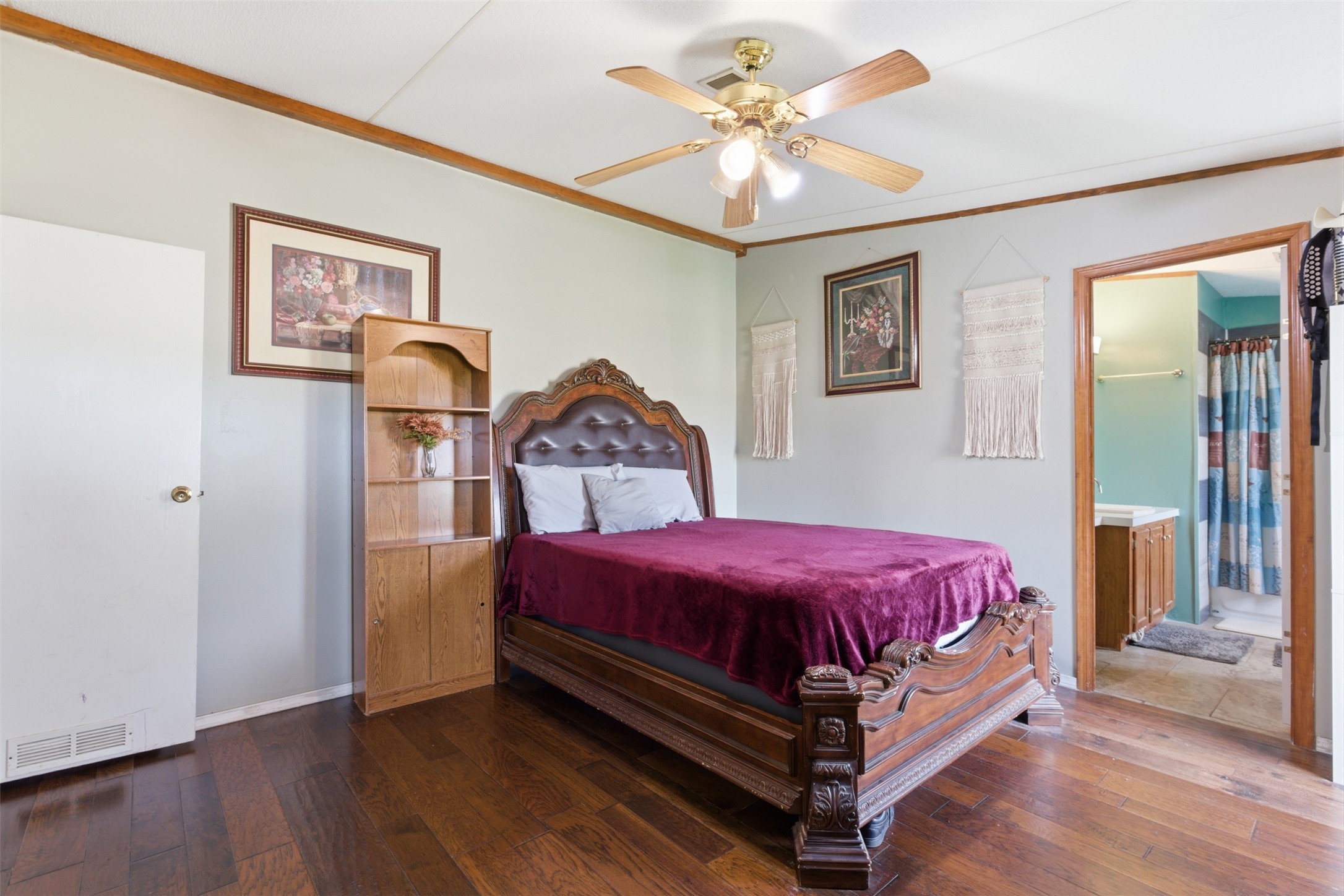1150 Walter Hoffman Road Cedar Creek, TX 78612 - Photo 21 of 25 Bedroom featuring crown molding, wood-type flooring, ceiling fan, and connected bathroom