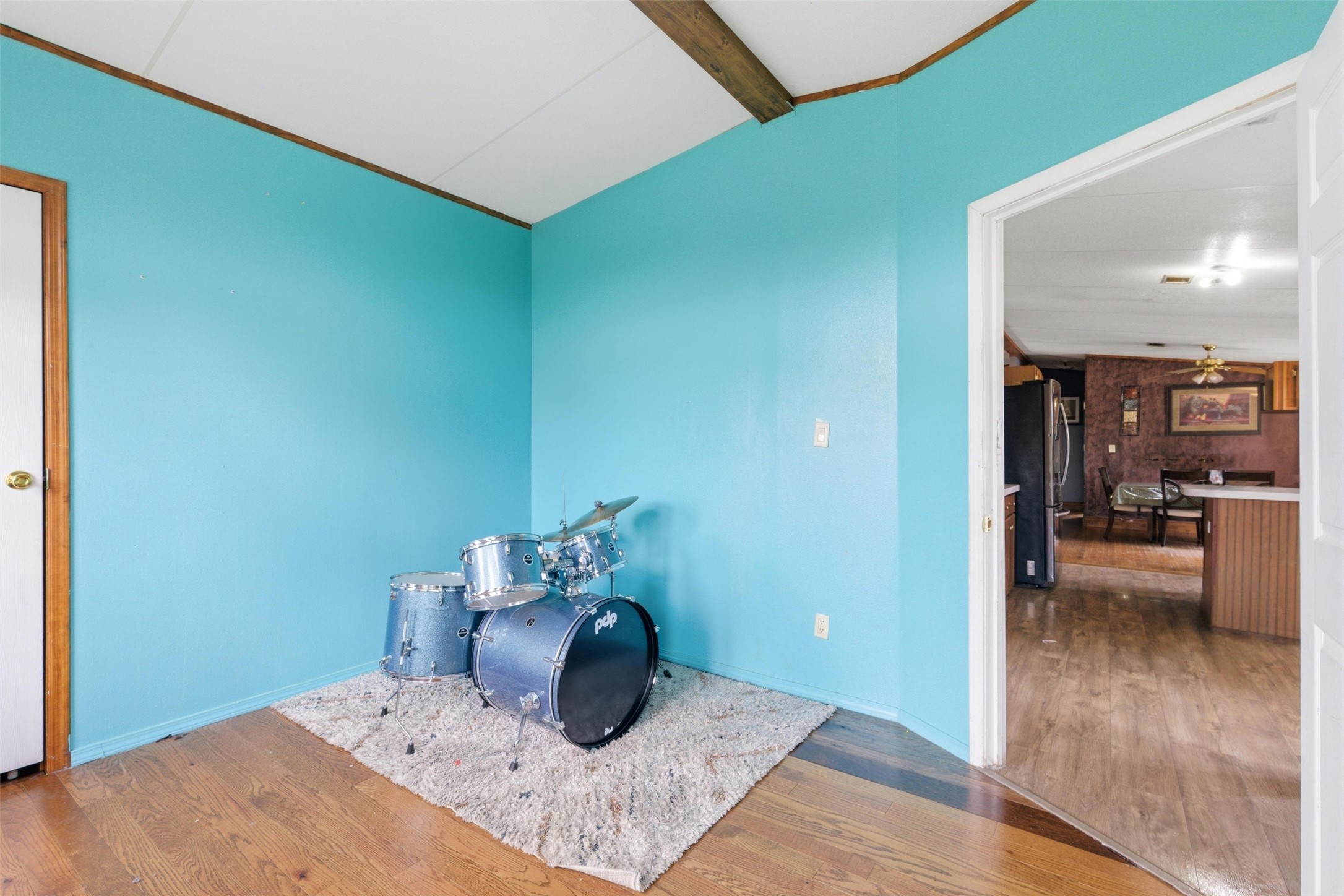 1150 Walter Hoffman Road Cedar Creek, TX 78612 - Photo 24 of 25 Unfurnished room featuring wood finished floors, beamed ceiling, and a ceiling fan