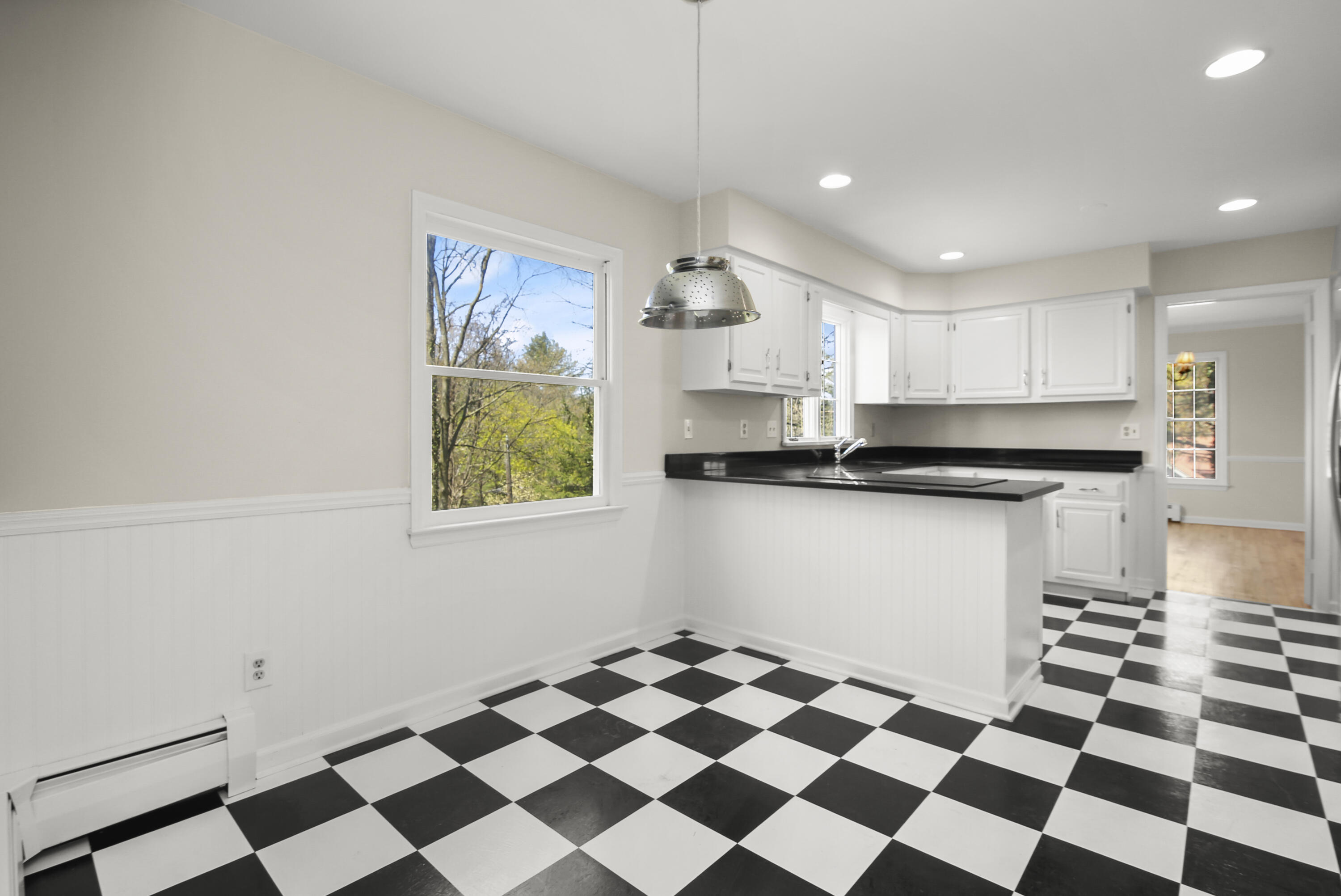 5 Barringer Road Darien, CT 06820 - Photo 11 of 39 a kitchen with a checkered floor and white cabinets