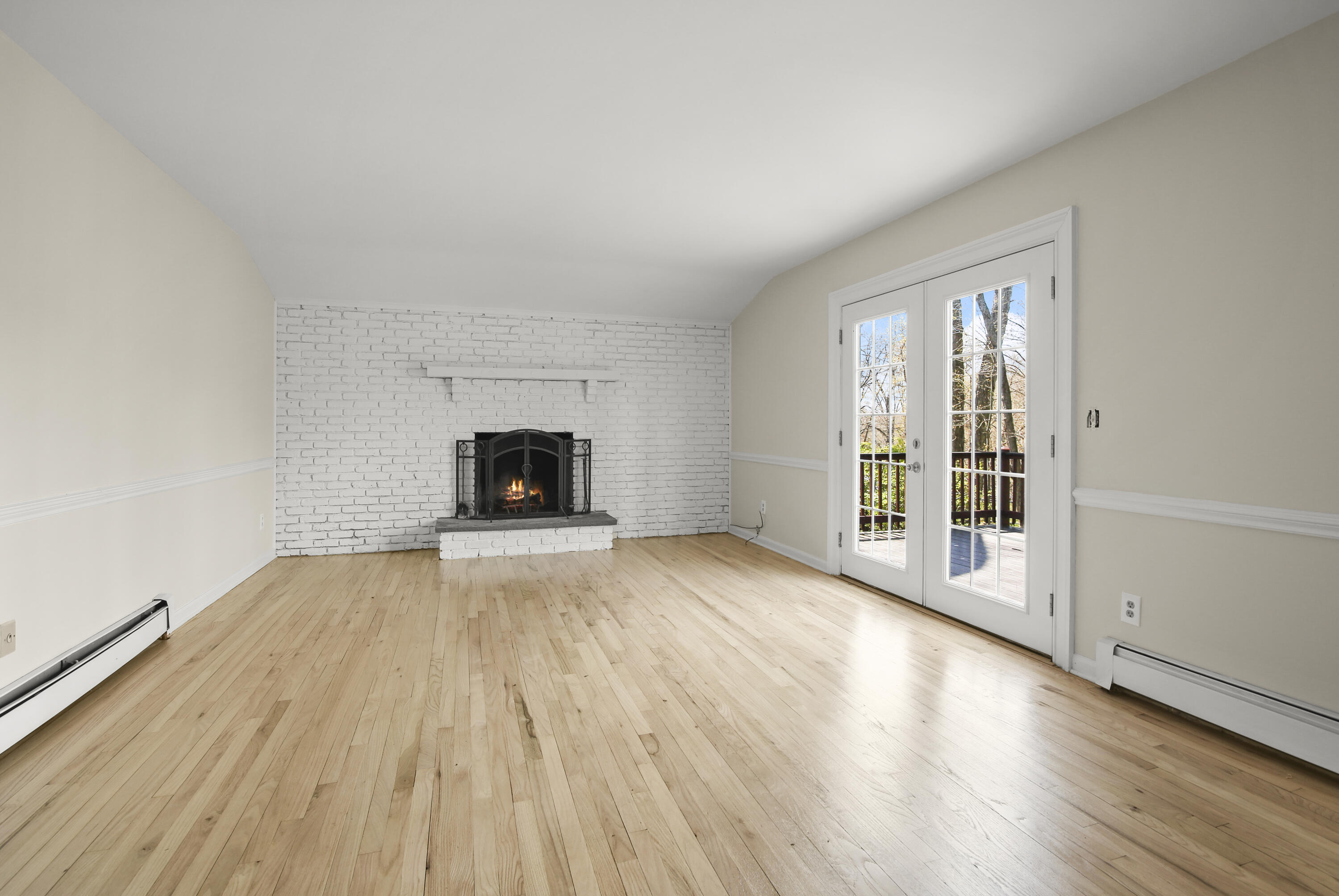 5 Barringer Road Darien, CT 06820 - Photo 15 of 39 an empty room with wooden floor and fireplace