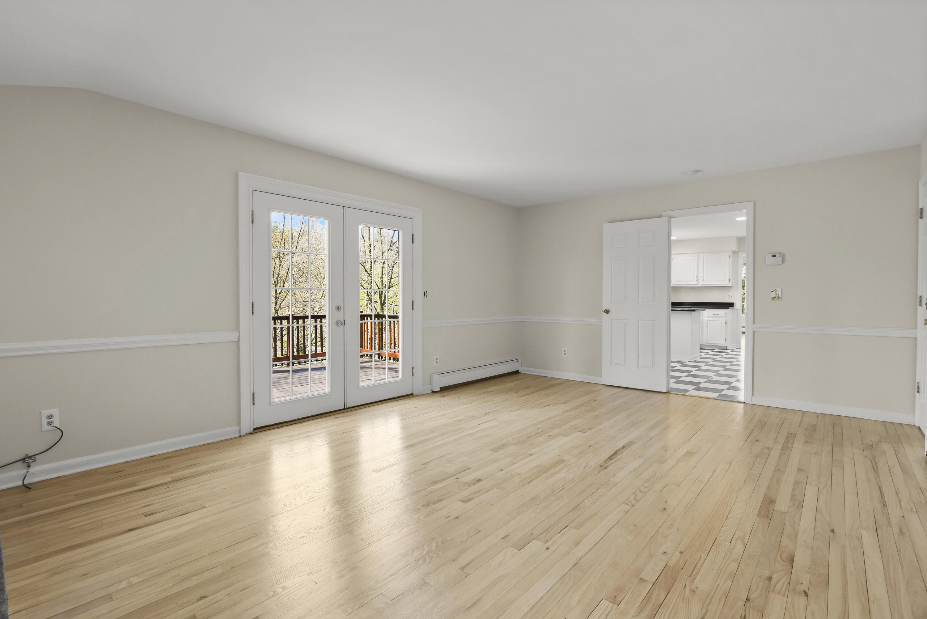 5 Barringer Road Darien, CT 06820 - Photo 16 of 39 a view of an empty room with wooden floor and a window