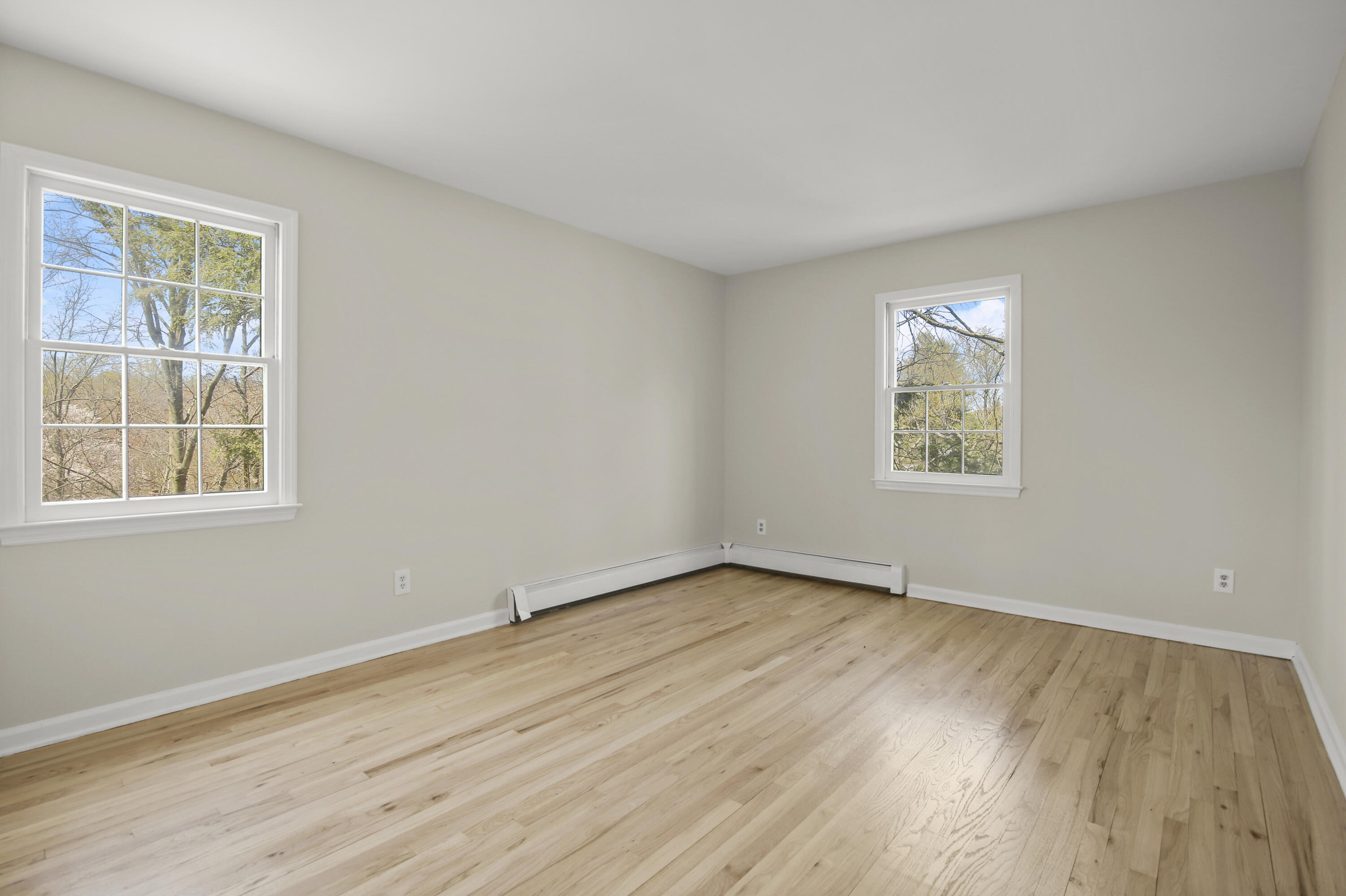 5 Barringer Road Darien, CT 06820 - Photo 20 of 39 a view of an empty room with wooden floor and a window