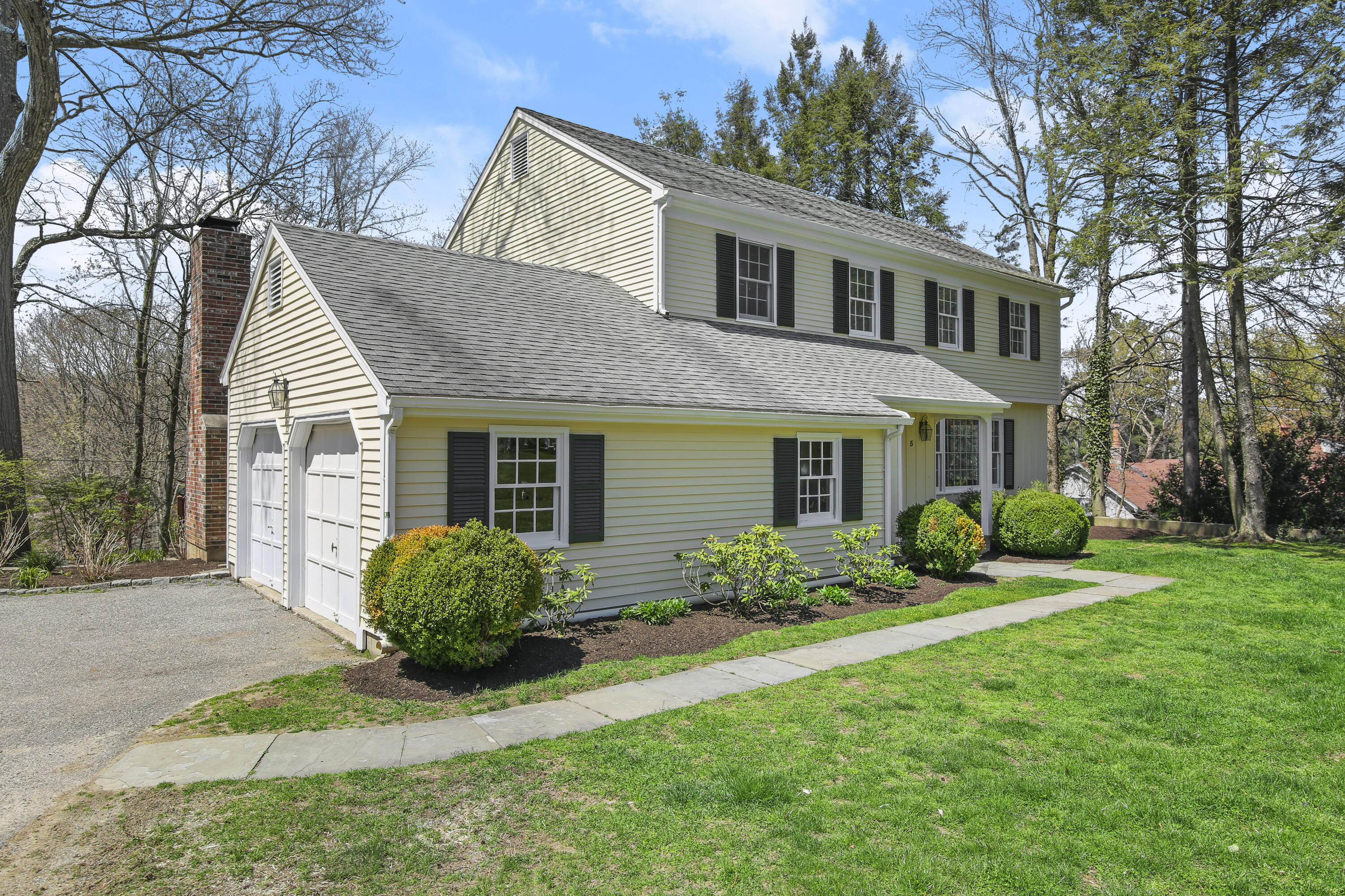 5 Barringer Road Darien, CT 06820 - Photo 2 of 39 a view of a house with a yard and plants