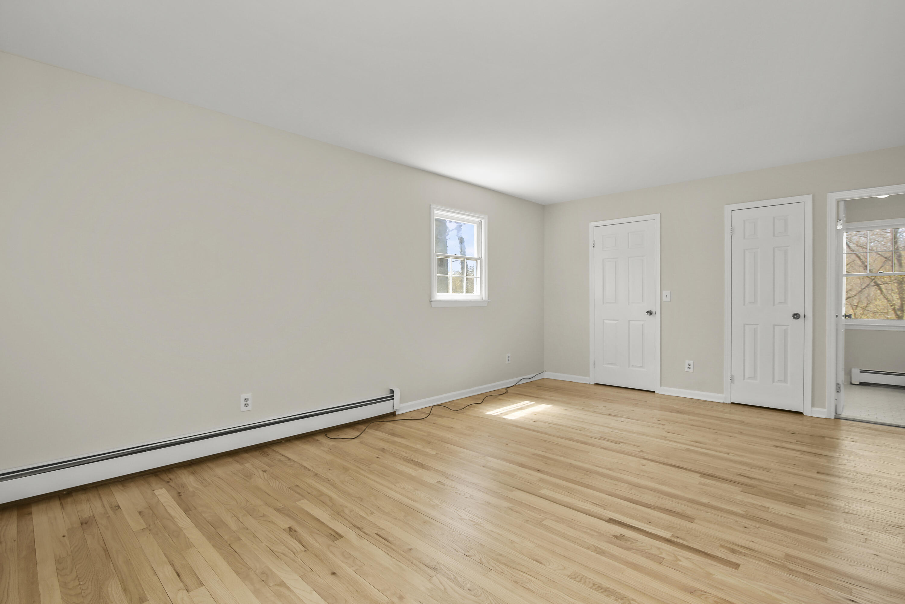 5 Barringer Road Darien, CT 06820 - Photo 22 of 39 an empty room with wooden floor and windows