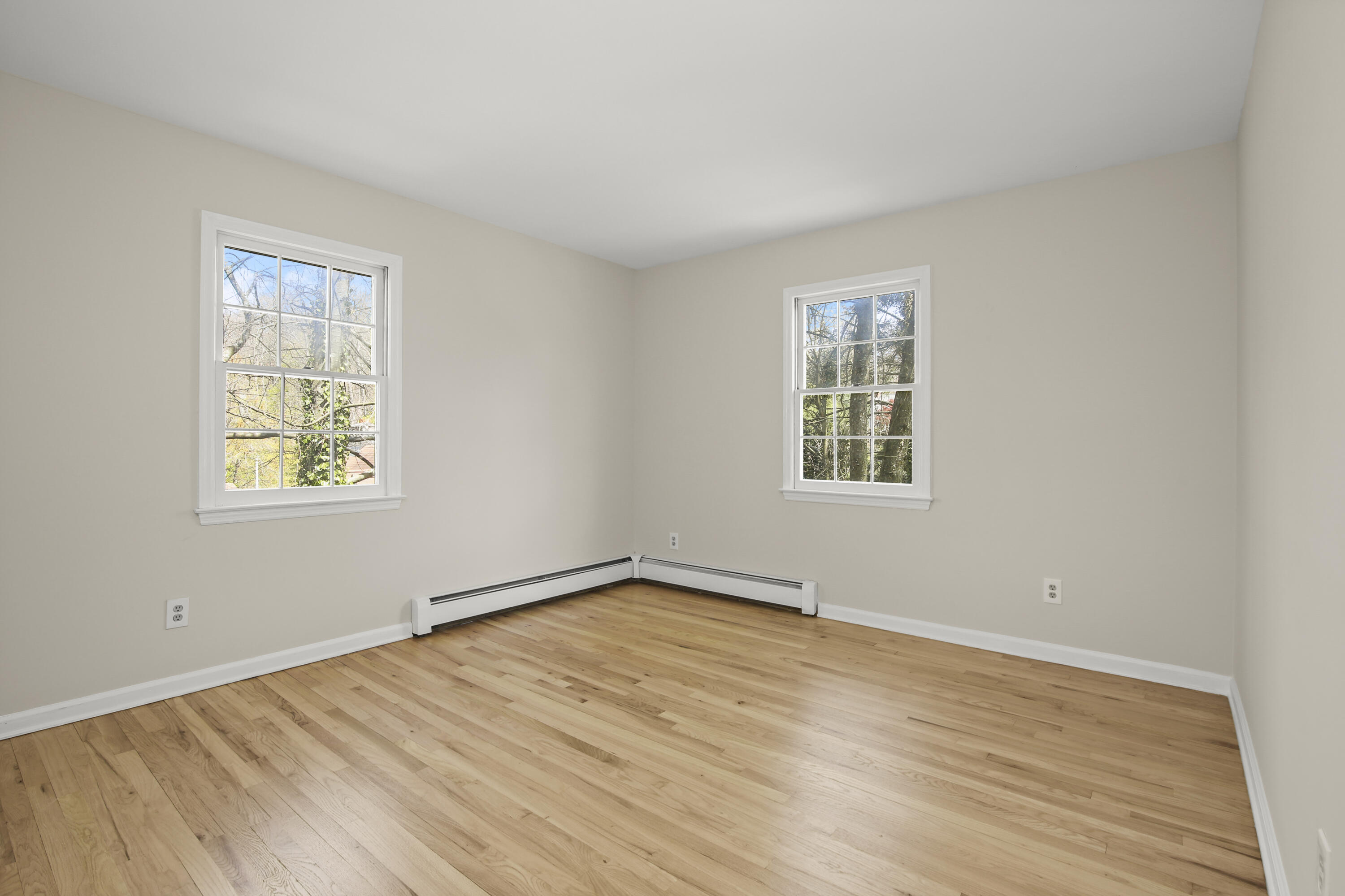 5 Barringer Road Darien, CT 06820 - Photo 23 of 39 a view of an empty room with wooden floor and a window