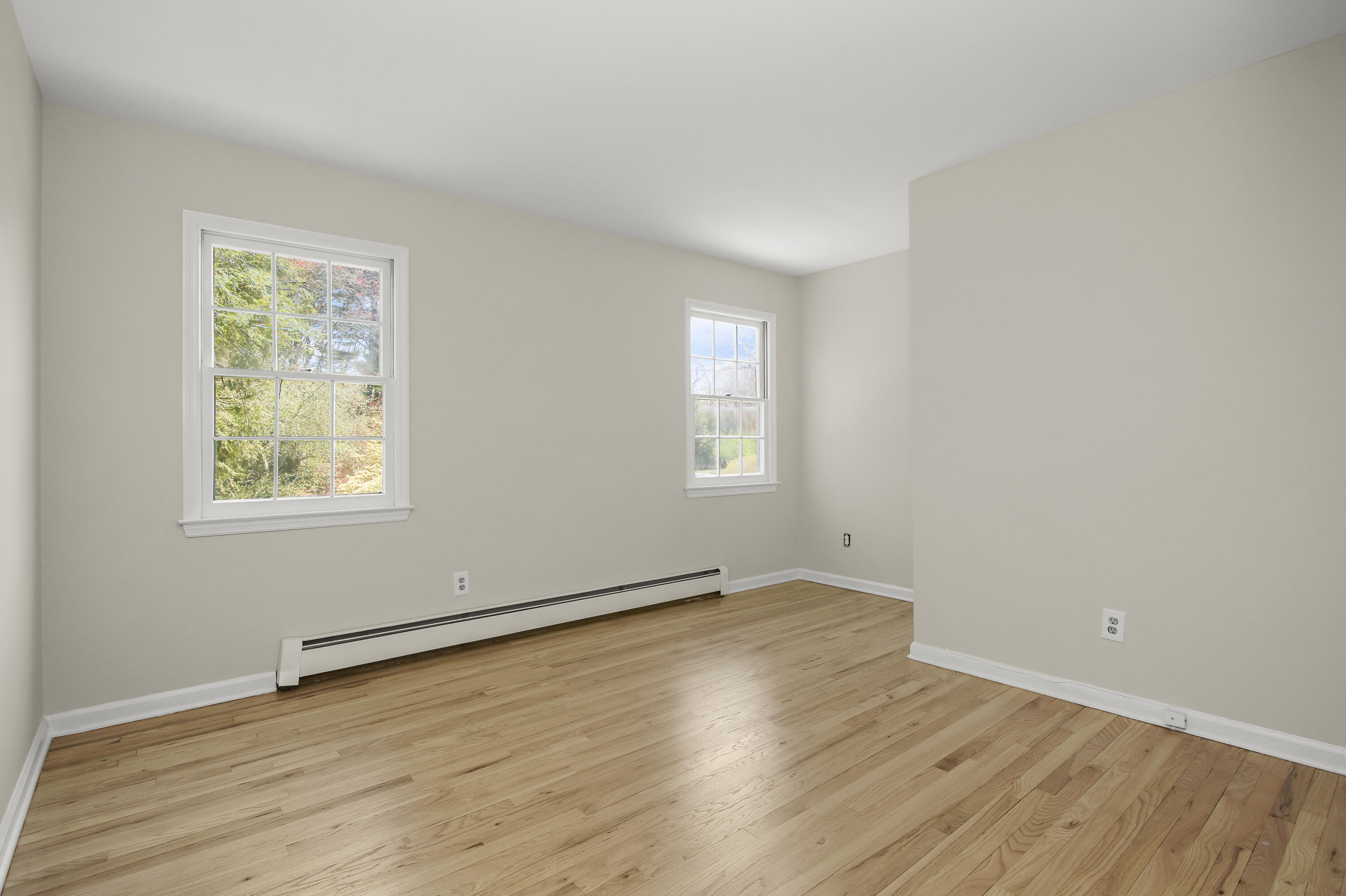 5 Barringer Road Darien, CT 06820 - Photo 24 of 39 an empty room with wooden floor and windows