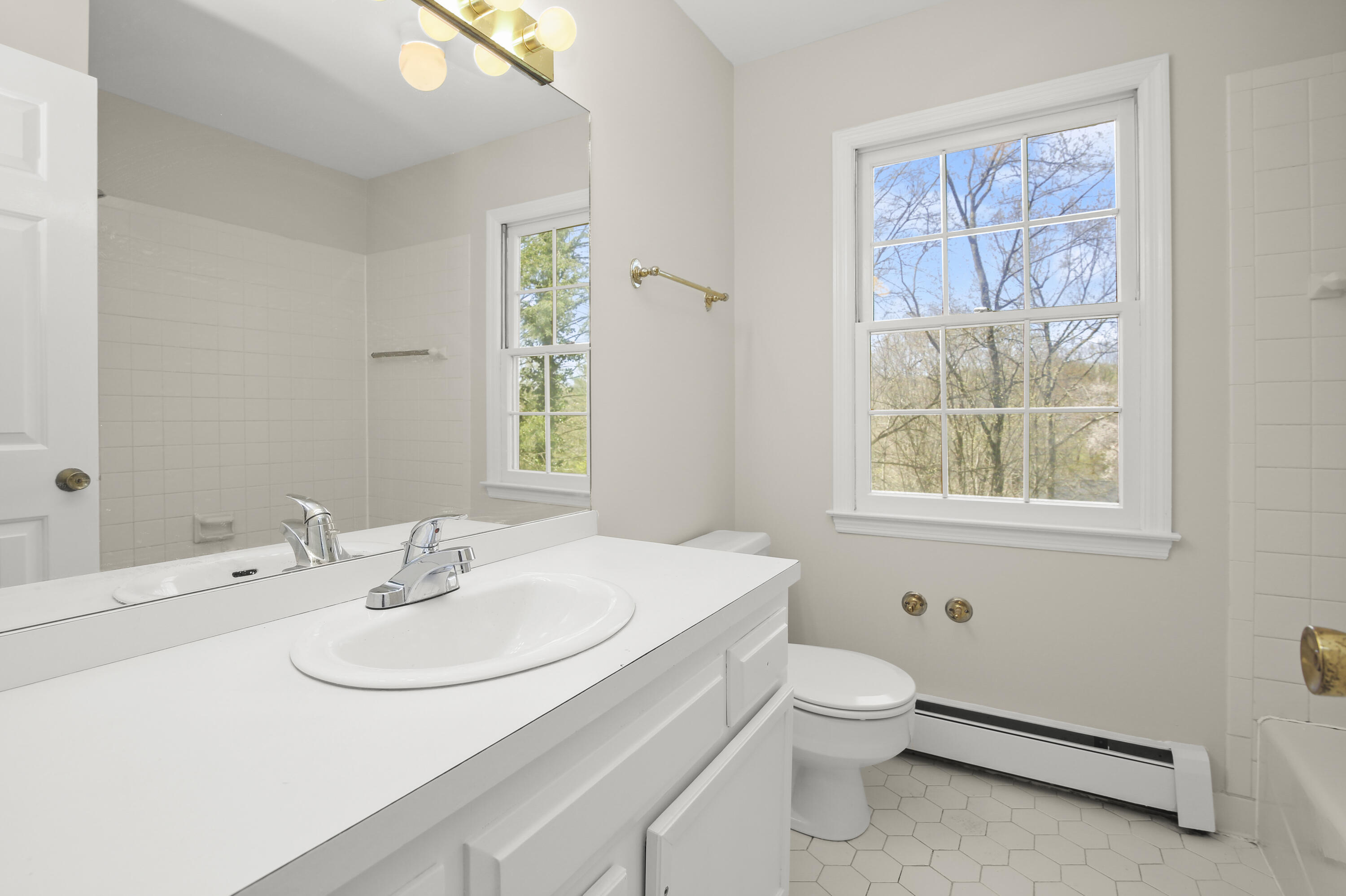 5 Barringer Road Darien, CT 06820 - Photo 25 of 39 a bathroom with a sink a toilet and a window