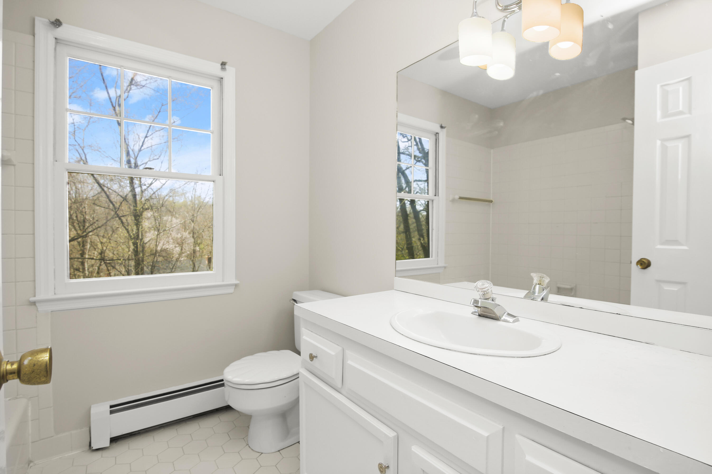 5 Barringer Road Darien, CT 06820 - Photo 27 of 39 a bathroom with a sink a toilet and a mirror