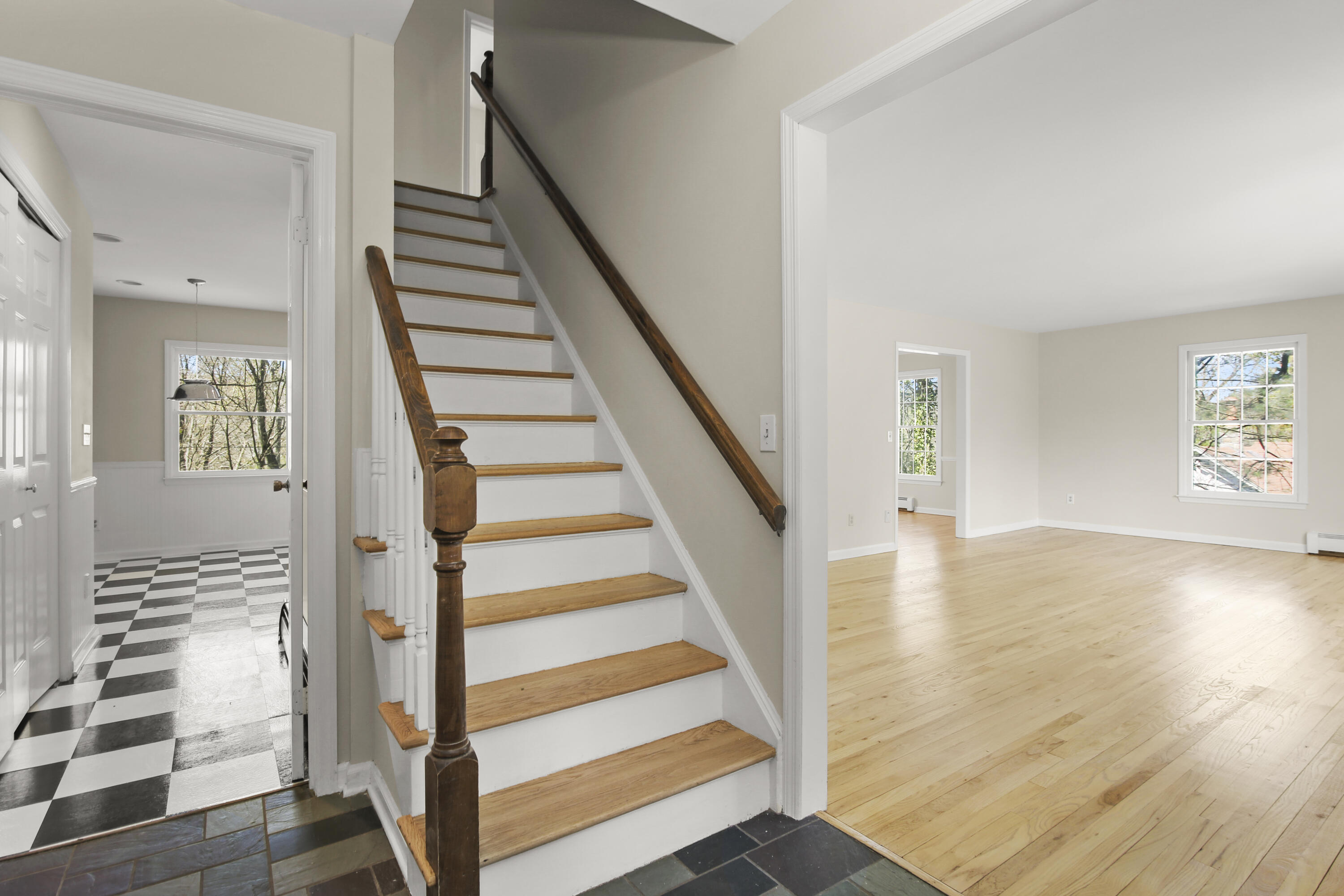 5 Barringer Road Darien, CT 06820 - Photo 5 of 39 a view of front door with wooden floor and stairs