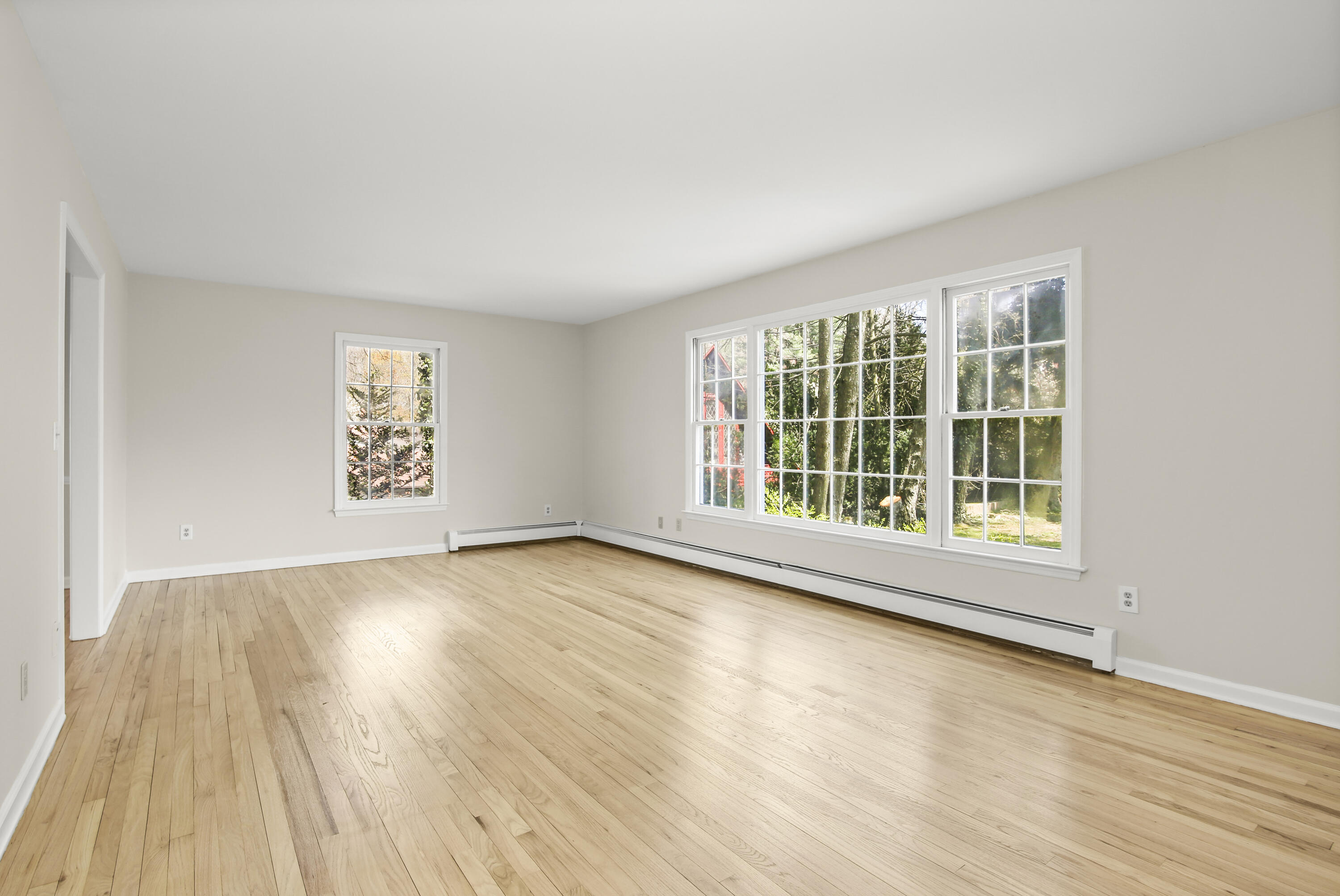 5 Barringer Road Darien, CT 06820 - Photo 6 of 39 a view of an empty room with wooden floor and a window
