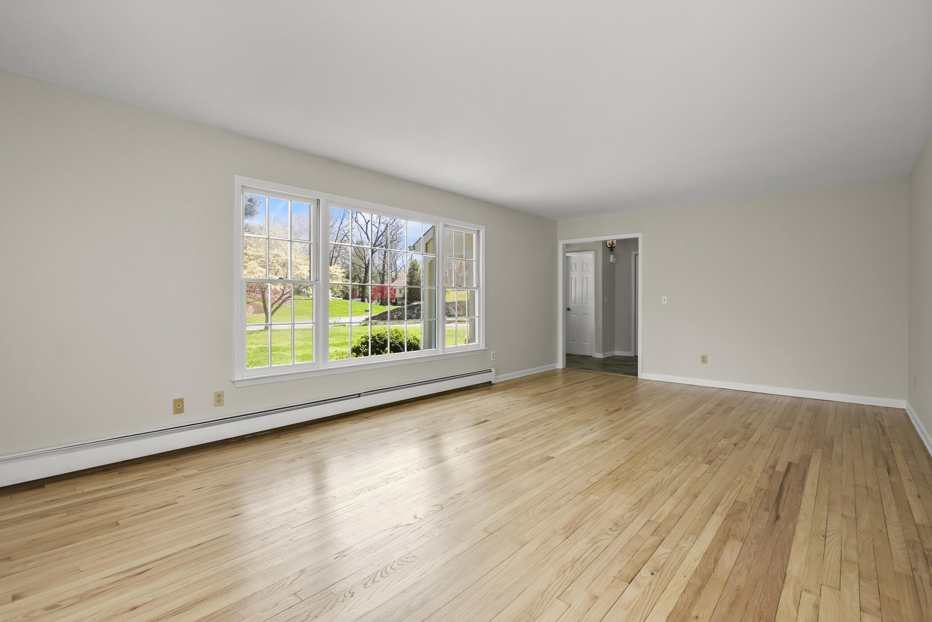 5 Barringer Road Darien, CT 06820 - Photo 7 of 39 wooden floor in an empty room with a window
